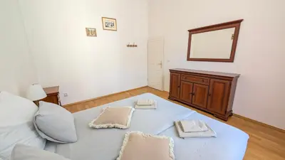 a bedroom with a bed with two pillows and a mirror at Riverside Gem w Balcony View in Prague