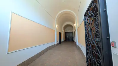 a hallway in a building with a large mirror on the wall at Riverside Gem w Balcony View in Prague