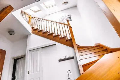 a spiral staircase in a house with a white wall at Central Riverside Duplex loft in Prague