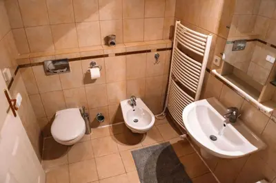 a small bathroom with a toilet and a sink at Central Riverside Duplex loft in Prague
