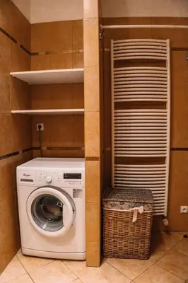 a laundry room with a washing machine and a basket at Central Riverside Duplex loft in Prague