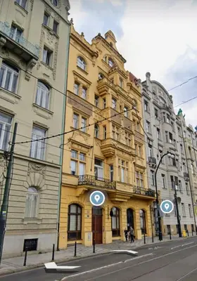 a yellow building on the side of a street at Central Riverside Duplex loft in Prague