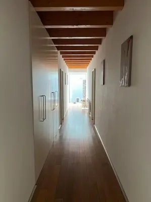 a hallway with white walls and a wooden ceiling at Klokočná in Klokočná