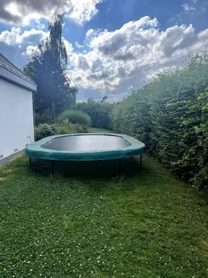 a green bath tub sitting in the grass at Klokočná in Klokočná