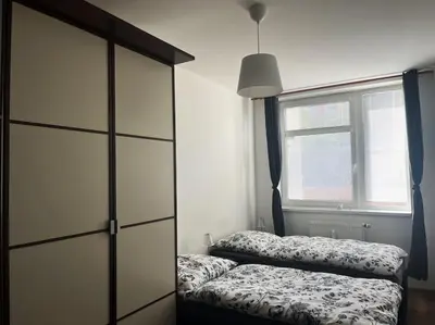 a bedroom with two beds and a large window at Praha 5 Barrandov- Apartmán Daniela in Prague