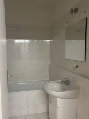 a white bathroom with a sink and a bath tub at Praha 5 Barrandov- Apartmán Daniela in Prague