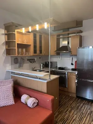 a kitchen with a red couch and a refrigerator at Praha 5 Barrandov- Apartmán Daniela in Prague