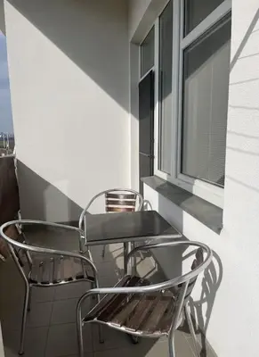two chairs sitting on a balcony with a window at Praha 5 Barrandov- Apartmán Daniela in Prague