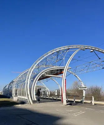 a metal bridge with a person walking under it at Praha 5 Barrandov- Apartmán Daniela in Prague