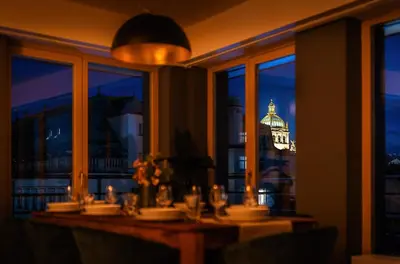 a table with a view of a building at night at Wenceslas sq SOHO Boutique Hotel & Premium Suites in Prague