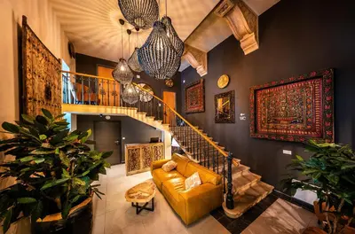 a living room with a couch and a spiral staircase at Wenceslas sq SOHO Boutique Hotel & Premium Suites in Prague