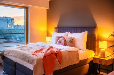 a bedroom with a large bed with a large window at Wenceslas sq SOHO Boutique Hotel & Premium Suites in Prague