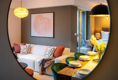 a living room with a white couch and a table at Wenceslas sq SOHO Boutique Hotel & Premium Suites in Prague