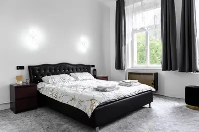 a bedroom with a bed and a window at Apartmen-Квартира in Prague
