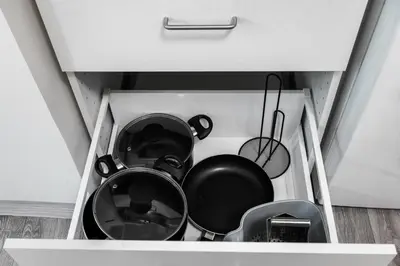 a drawer filled with pots and pans in a kitchen at Apartmen-Квартира in Prague