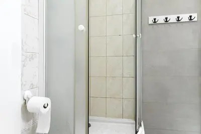 a bathroom with a shower with a roll of toilet paper at Apartmen-Квартира in Prague
