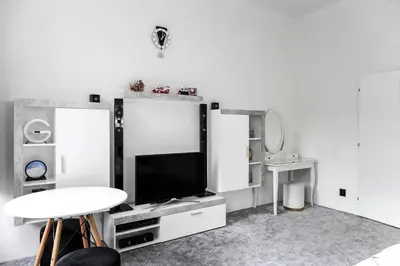 a living room with a tv and a table at Apartmen-Квартира in Prague