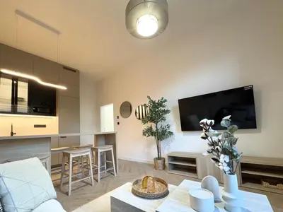 a living room with a couch and a table at Rentero Golden Wabi-Sabi Apartment, Prague in Prague