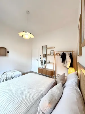 a bedroom with a bed and a mirror at Rentero Golden Wabi-Sabi Apartment, Prague in Prague