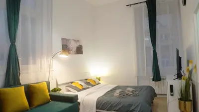 a bedroom with a bed and a couch at Quiet cozy apartment in the center in Prague