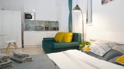 a living room with a green couch and yellow pillows at Quiet cozy apartment in the center in Prague