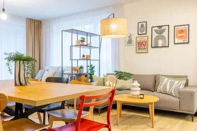 a living room with a table and a couch at Spacious 3BR - 2 Parking Spots, Full Kitchen, by Gravity Prague in Prague