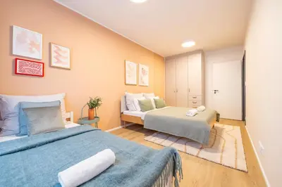 a bedroom with two beds and a couch at Spacious 3BR - 2 Parking Spots, Full Kitchen, by Gravity Prague in Prague