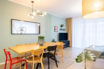 a dining room and living room with a table and chairs at Spacious 3BR - 2 Parking Spots, Full Kitchen, by Gravity Prague in Prague