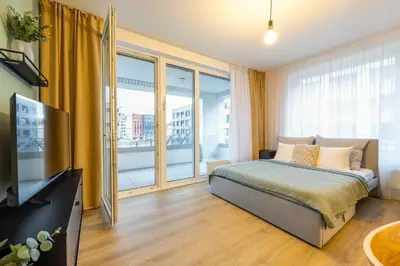 a bedroom with a bed and a large window at Spacious 3BR - 2 Parking Spots, Full Kitchen, by Gravity Prague in Prague