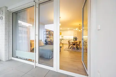 a sliding glass door leading into a room with a bedroom at Spacious 3BR - 2 Parking Spots, Full Kitchen, by Gravity Prague in Prague