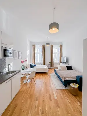 a kitchen and living room with a bed and a couch at TurnKey I Wenceslas Square Apartments in Prague