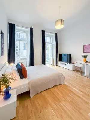 a large bedroom with a bed and a television at TurnKey I Wenceslas Square Apartments in Prague