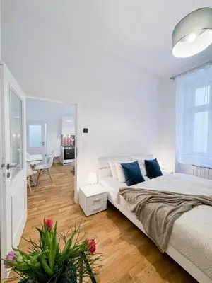 a white bedroom with a bed and a desk at TurnKey I Wenceslas Square Apartments in Prague
