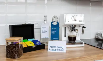 a kitchen counter with a coffee maker and a sign at TurnKey I Wenceslas Square Apartments in Prague