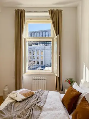 a bedroom with a bed in front of a window at TurnKey I Wenceslas Square Apartments in Prague