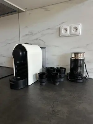 a kitchen with a microwave and some black pots at Pasta Party Apartment, Free Parking, Fully Equipped in Prague
