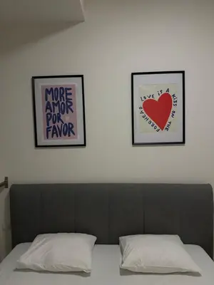 a bed with two pictures on the wall above it at Pasta Party Apartment, Free Parking, Fully Equipped in Prague