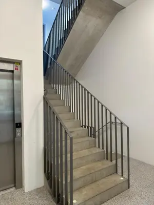 a staircase in a building with a metal railing at Pasta Party Apartment, Free Parking, Fully Equipped in Prague
