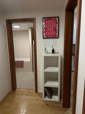 a hallway with a white book shelf and a mirror at Pasta Party Apartment, Free Parking, Fully Equipped in Prague