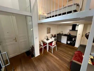 a living room with a table and a loft at Opletalova Residence 1min from Wenceslas Square in Prague