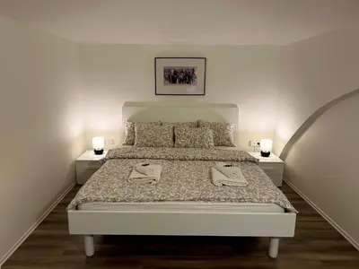 a bedroom with a bed with two towels on it at Opletalova Residence 1min from Wenceslas Square in Prague