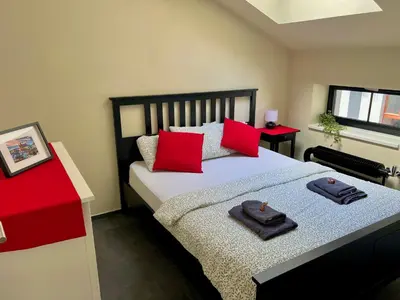 a bedroom with a bed with two towels on it at Opletalova Residence 1min from Wenceslas Square in Prague