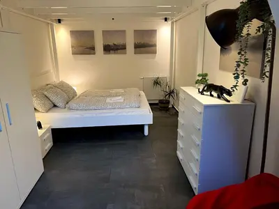 a small bedroom with a bed and a dresser at Opletalova Residence 1min from Wenceslas Square in Prague