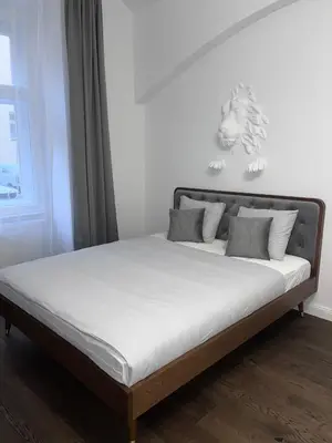 a bed in a room with a white at Saint Petr in Prague