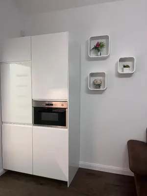 a white kitchen with a refrigerator and a stove at Saint Petr in Prague