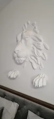 a painting of a lion head on a wall at Saint Petr in Prague