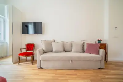 a living room with a couch and a red chair at J3 Prague Apartments in Prague