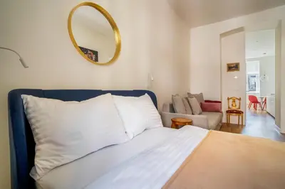 a bedroom with a bed with a mirror on the wall at J3 Prague Apartments in Prague