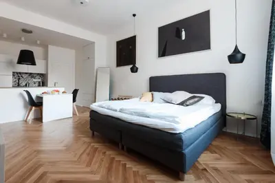 a bedroom with a large bed and a desk at Prague Days - Art Deco Studio near Main Train Station in Prague