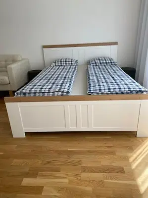 a white bed with two pillows on top of it at Quiet apartment near Prague centre in Prague